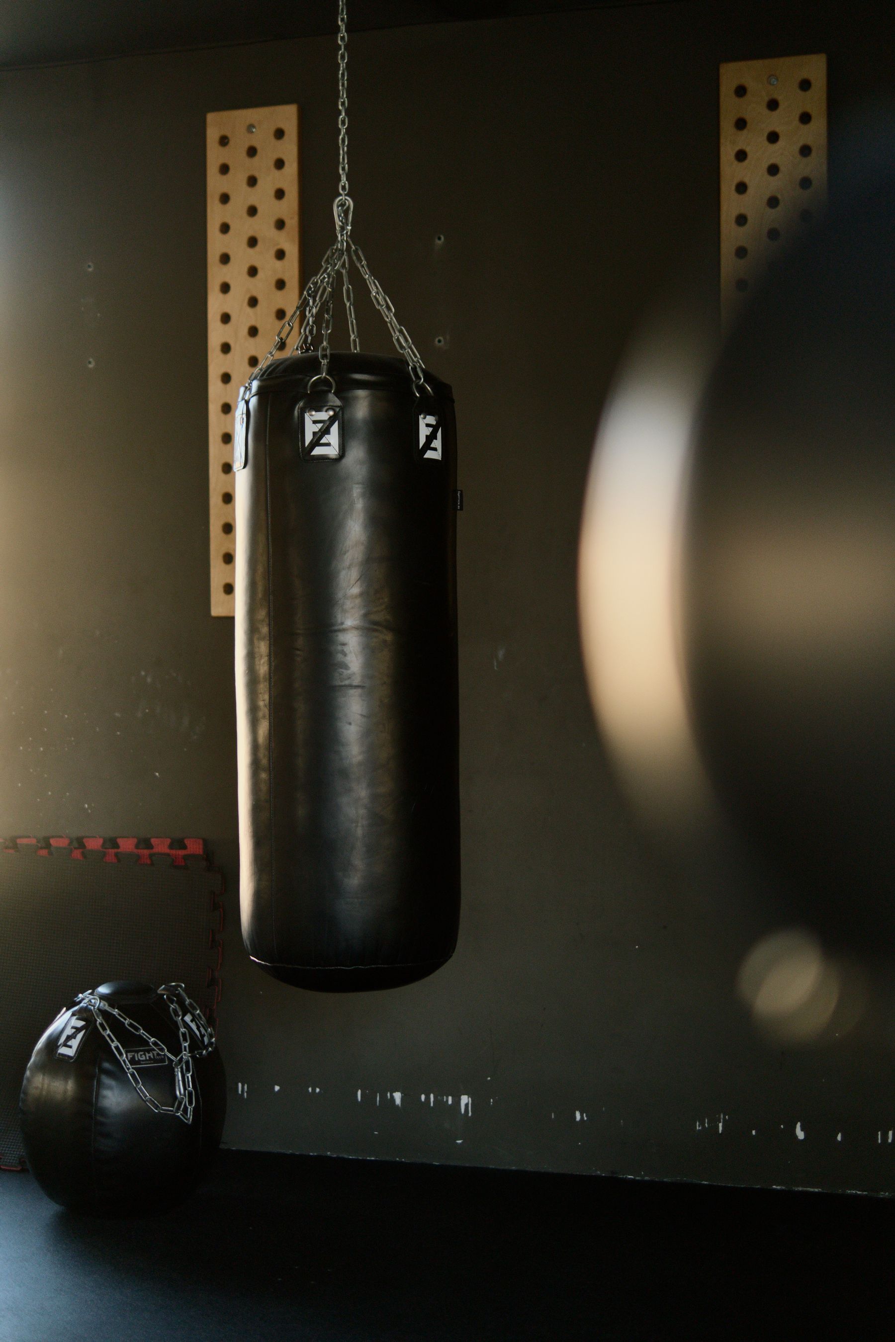 Heavy bag hanging in a dark gym
